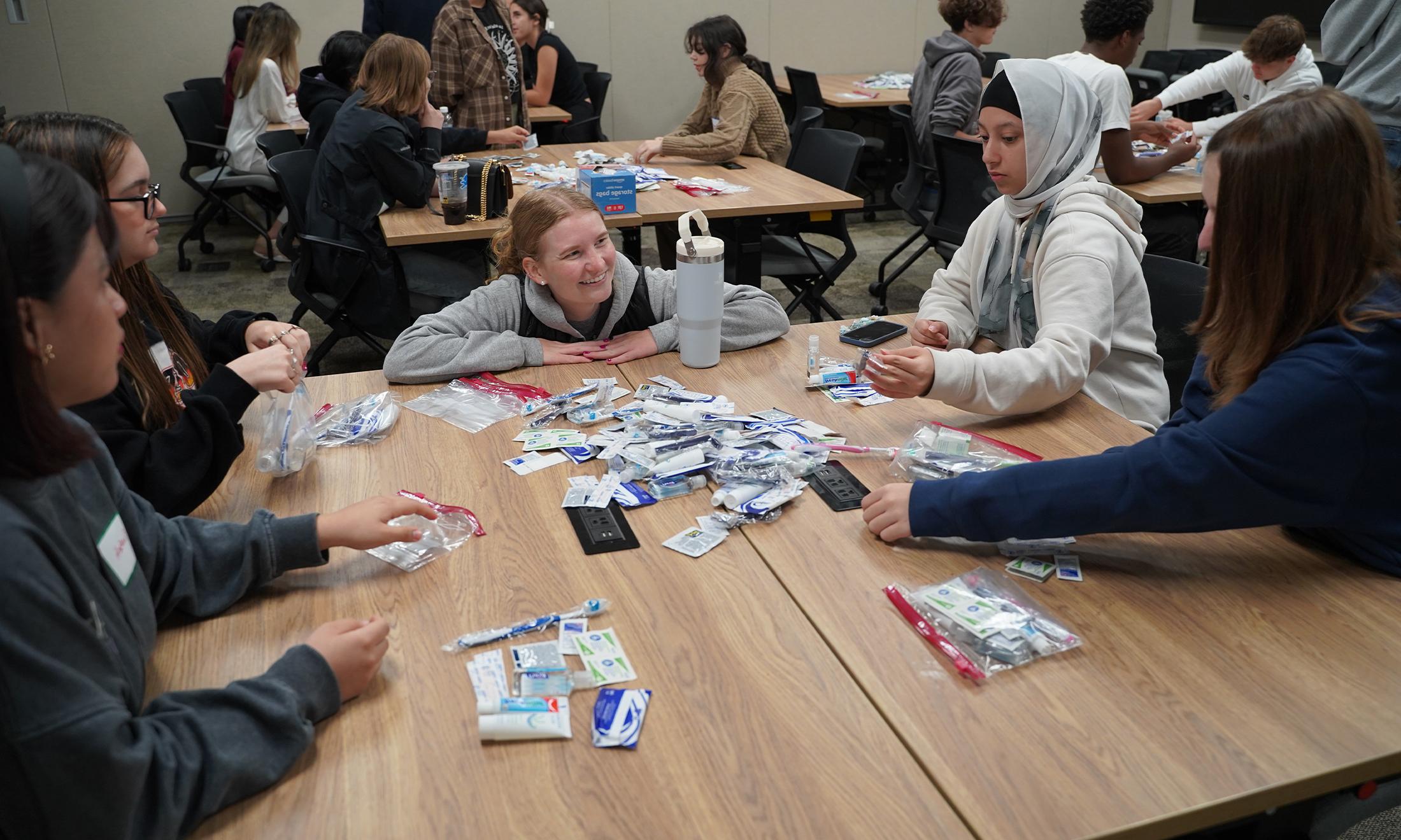 An image of a fourth-year medical student talking with Saturday Academy participants